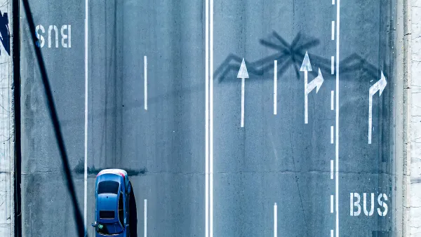 Bird's eye view of multi-lane road with dedicated bus lanes.