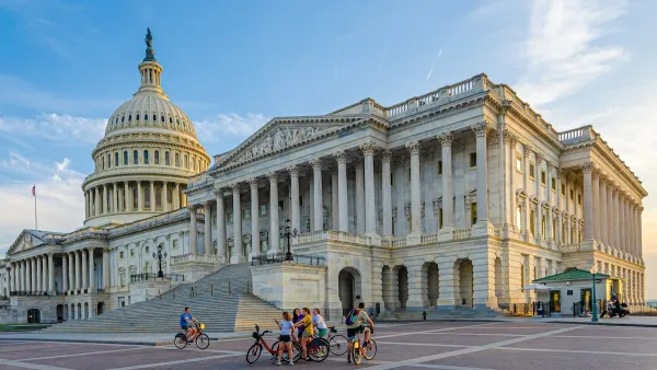 Wide shot of group of people with bikes standing in plaza near U.S. Capitol in Washington, D.C.