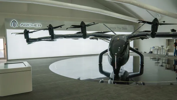 Archer Aviation Midnight eVTOL aircraft on display at Dubai Airshow November 13th 2023, dark colors, bright background, indoors. Electric aircraft, electric helicopter.