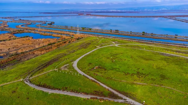 Aerial view of Sunnyvale Bay Trail on top of former landfill. Scenic view of San Francisco Bay with levees, salt marshes and sloughs.