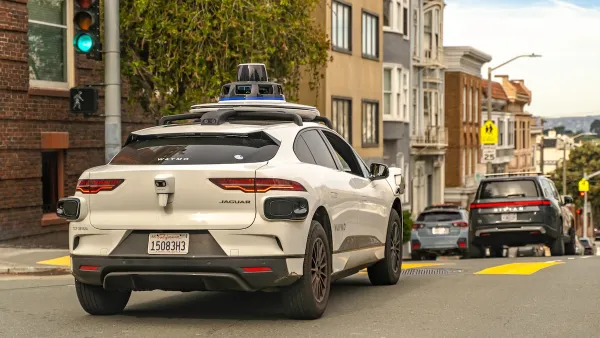 White Waymo self-driving car on street in San Francisco, California.