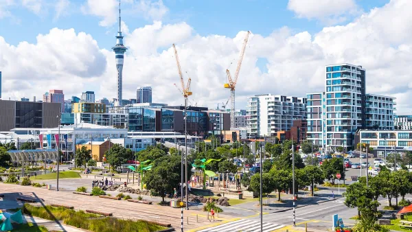 View of Auckland, New Zealand with construction cranes.
