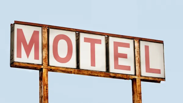 Close-up of faded old MOTEL sign with red letters on white placards against blue sky.