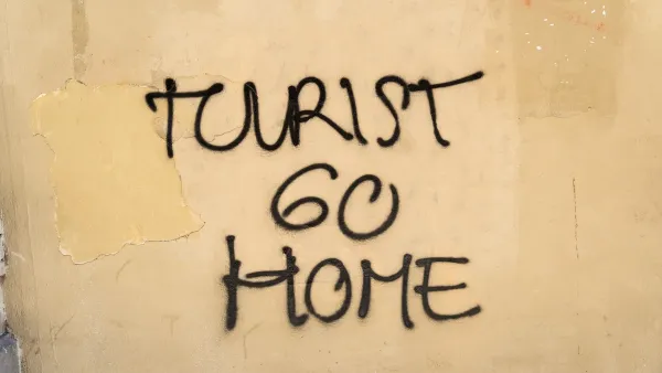 "Tourist go home" graffiti on a wall in Barcelona, Spain.