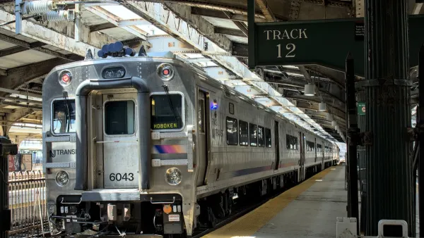 New Jersey Transit passenger rail commuter train at station in Hoboken, New Jersey with platform 12 sign.