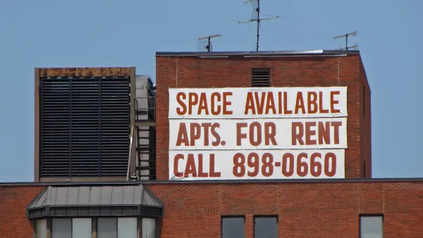 Large white banner with red letter reading "Space Available - Apts. for Rent - Call 898-0660" on brick building in Washington, D.C.