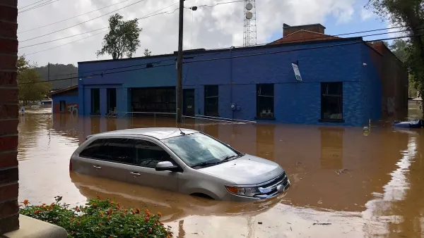Car half submerged in brown flood water in Asheville, North Carolina after Hurricane Helene.