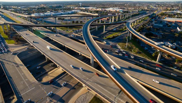 Aerial Texas Hill Country at sunset, with an aerial view of a highway interchange and Interstate 35 in Austin, Texas.