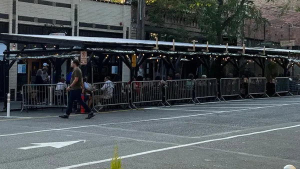 Covered pergolas for outdoor dining line the curb on Ballard Avenue, Seattle