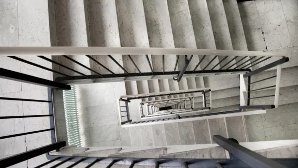 View looking down a multi-story apartment building staircase