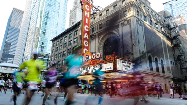 Runner passing the Chicago Theater are blurred as they pass by the camera for a race on the streets of Downtown Chicago.