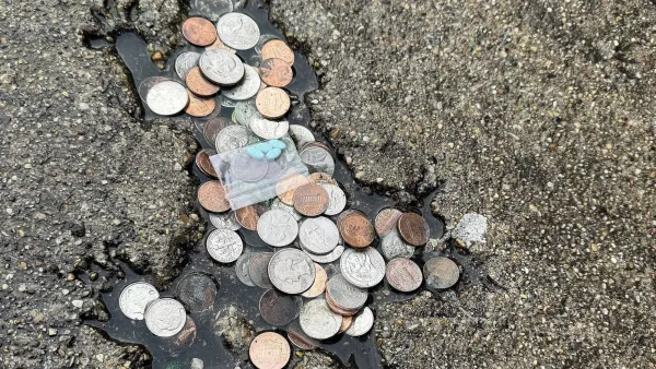 Rat shaped indentation on pavement, filled with coins