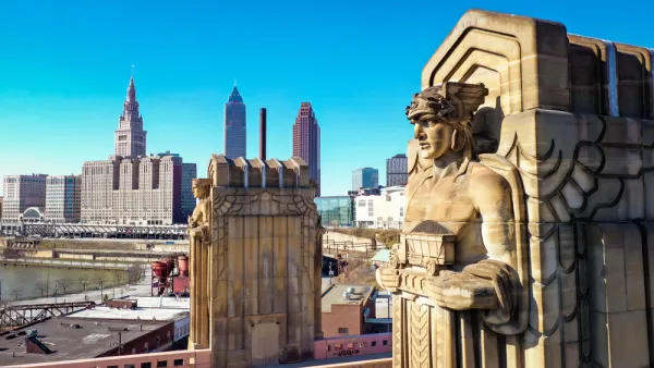One of the "Guardians of Traffic" in Cleveland, a scuplture of a large figure adorning a bridge in Cleveland. Downtown Cleveland is in the background.