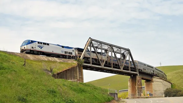 Amtrak Coast Starlight passenger train passing over bridge in Altamont Pass, California.