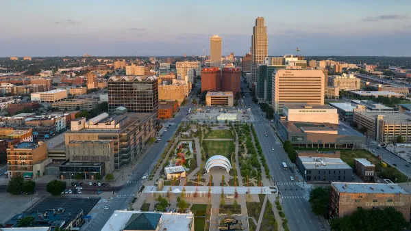 An aerial view of a park and the streets and high-rises of Downtown Omaha.