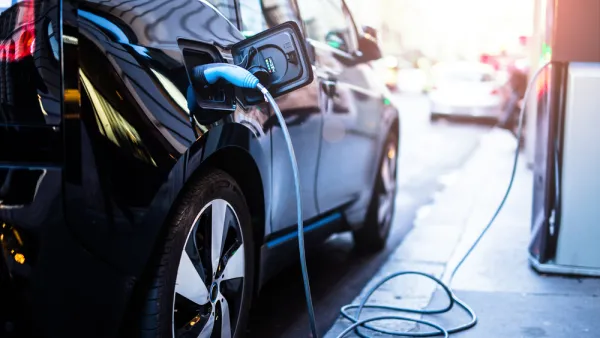 Electric car being charged at a station
