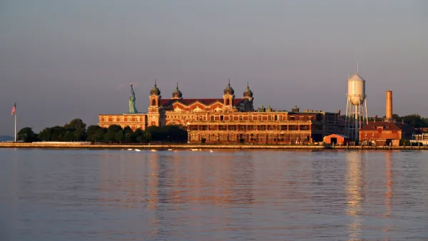 Ellis Island is shown across the water of the New York Harbor.
