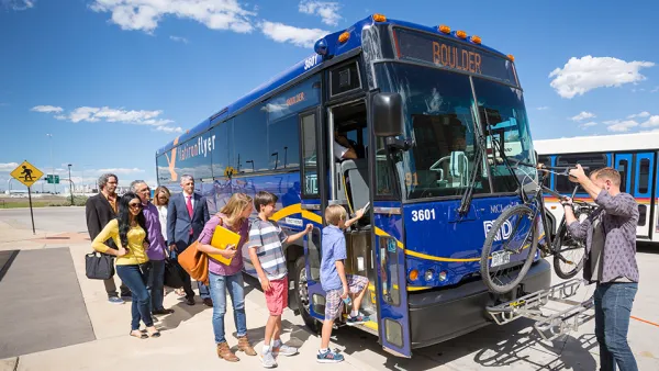 Blue Boulder bus with people boarding