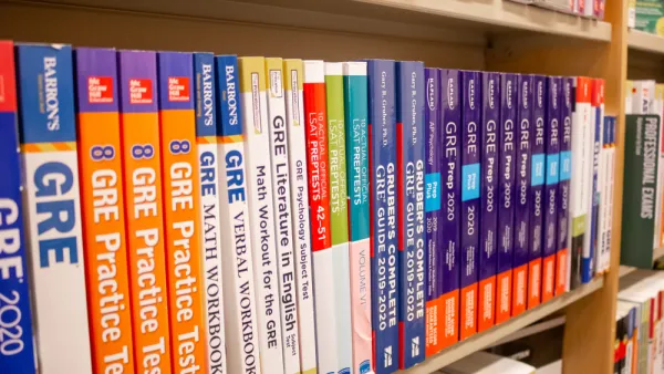 A row of GRE exam study books lined up neatly in a bookstore.
