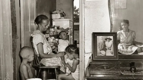 Mrs. Ella Watson, a government charwoman, with three grandchildren and her adopted daughter