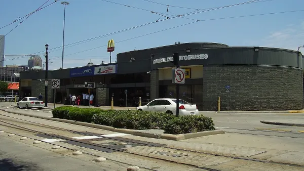 Greyhound bus station in Houston, Texas next to street with light rail tracks.