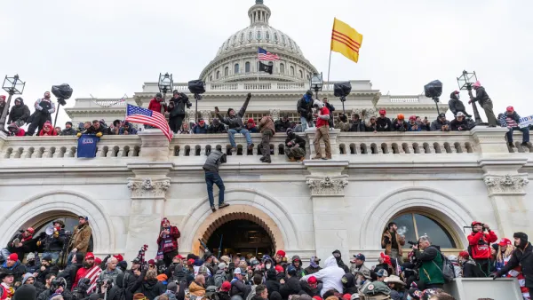 Trump supporting insurrectionists scale the walls of the U.S. Capitol Building on January 6, 2021.
