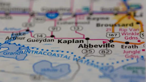 A map depicting a row of cities long a highway, focusing on the city of Kaplan with surrounding cities blurred.