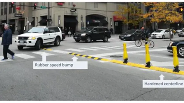 Crosswalk in Chicago with newly installed yellow delineators and speed bumps
