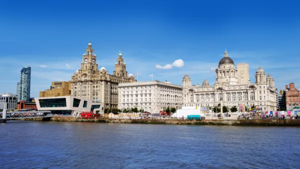 The historic waterfront of Liverpool looms above the water.
