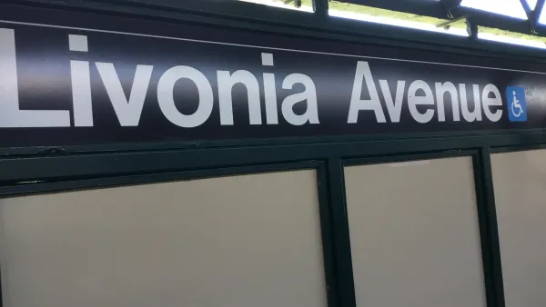 Close-up of black and white Livonia Avenue subway sign with blue accessibility symbol