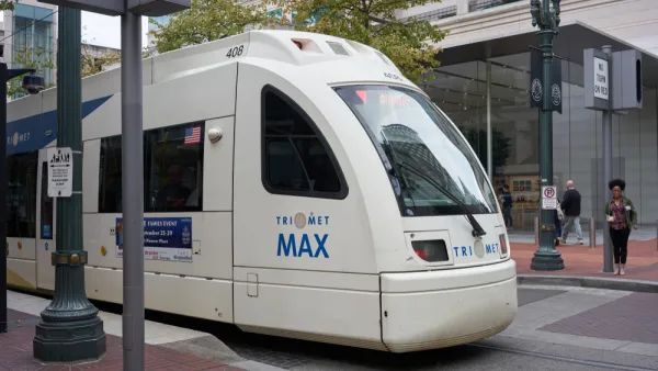 A TriMet MAX Red Line light rail train heading for the Portland International Airport comes to a stop at Pioneer Place in downtown Portland.