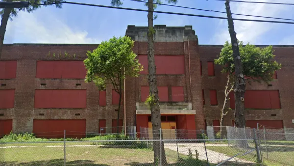 Google street view of vacant, boarded-up brick high school building in Memphis, Tennessee.