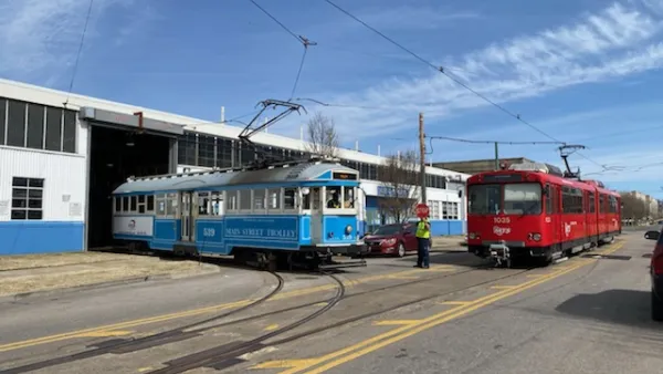 A pair of vintage Siemens–Duewag U2 trolleys roll out of a garage in Memphis.
