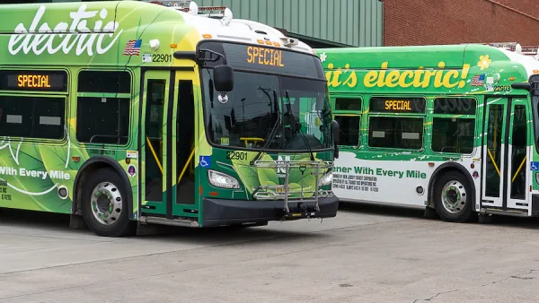 Parked green electric NJ Transit buses.