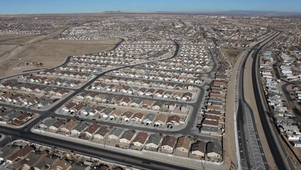 A spraling subdivision of single-family detached housing in a desert setting.