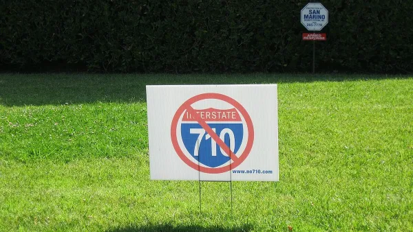 "No 710" lawn sign on green lawn.