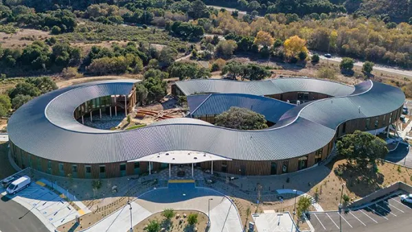 Aerial view of Ohana mental health facility in Monterey, California with wavy silver roof.