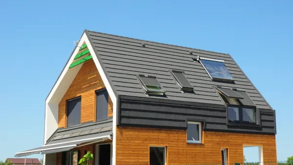 Modern Passive House Exterior. Modern energy efficiency house with skylight windows and solar panels on the roof top.
