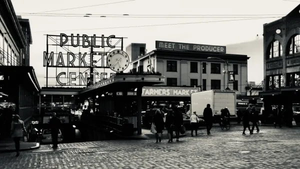 Black and white photo of Pike Place Market entrance in Seattle with "PUBLIC MARKET" and "Meet the producer" signs