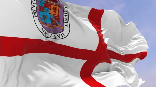 The flag of Prince George's County00a red croiss in a white field with a crest of arms in the upper left corner, blows in the wind.