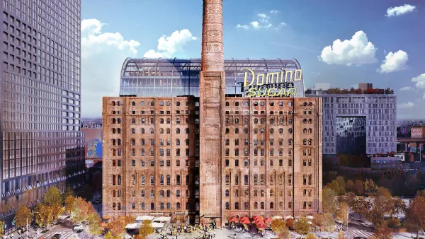 Historic brick sugar refinery building redeveloped with glass office tower inside and yellow Domino Sugar sign