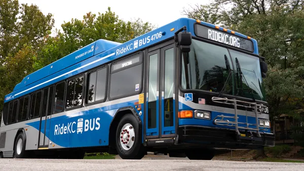 Blue RideKC bus in Kansas City with trees in background