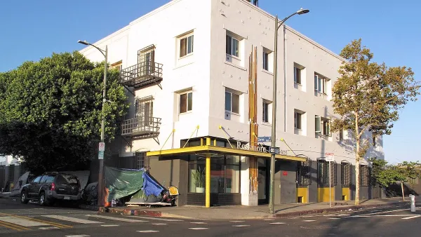 White three-story brick single-room occupancy hotel in downtown Los Angeles, California.