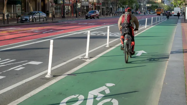 A cyclist commutes along a painted bike lan on Market Street in San Francisco.