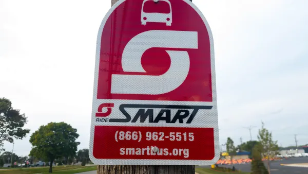 A sign for SMART Bus on a pole.