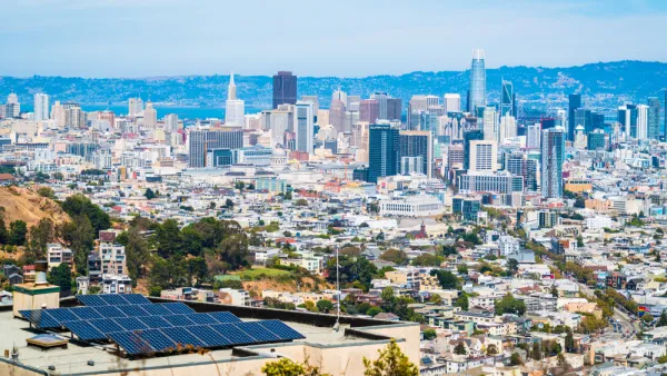 A sunny day in San Francisco, with a view of the city skyline with the Easy Bay Hills in the background.