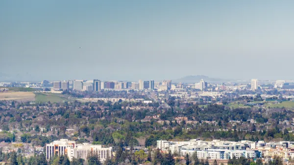A view out over the city of San Jose, with downtown highrises in the background distance and smoggy air hanging overhead.