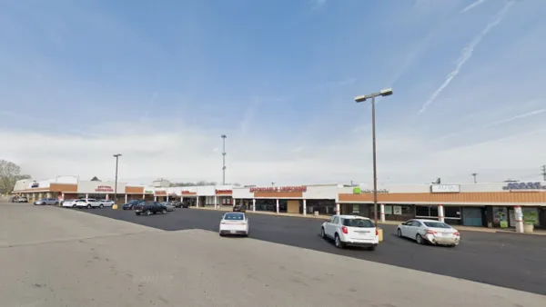 Google Maps view of one-story shopping center with large parking lot.
