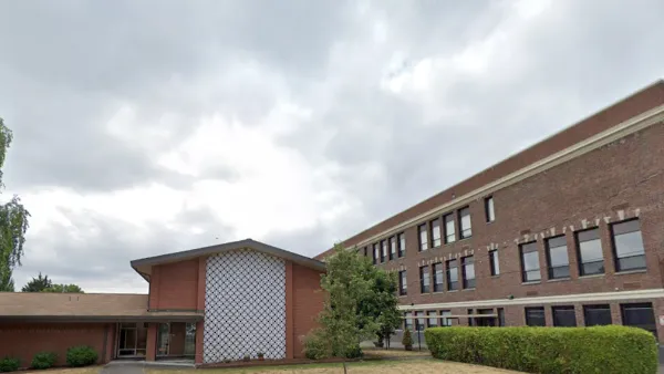 Google street view of red brick Catholic church in Seattle, Washington.