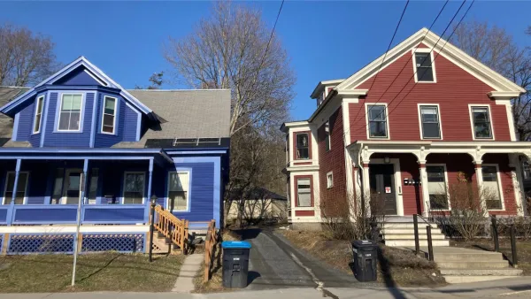 Blue and red colonial-style multifamily homes in Vermont.